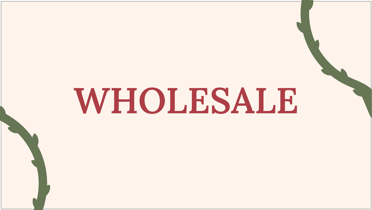 A graphic with the word 'WHOLESALE' in large red serif letters centered on a warm cream background, with green vine illustrations in the top-right and bottom-left corners.